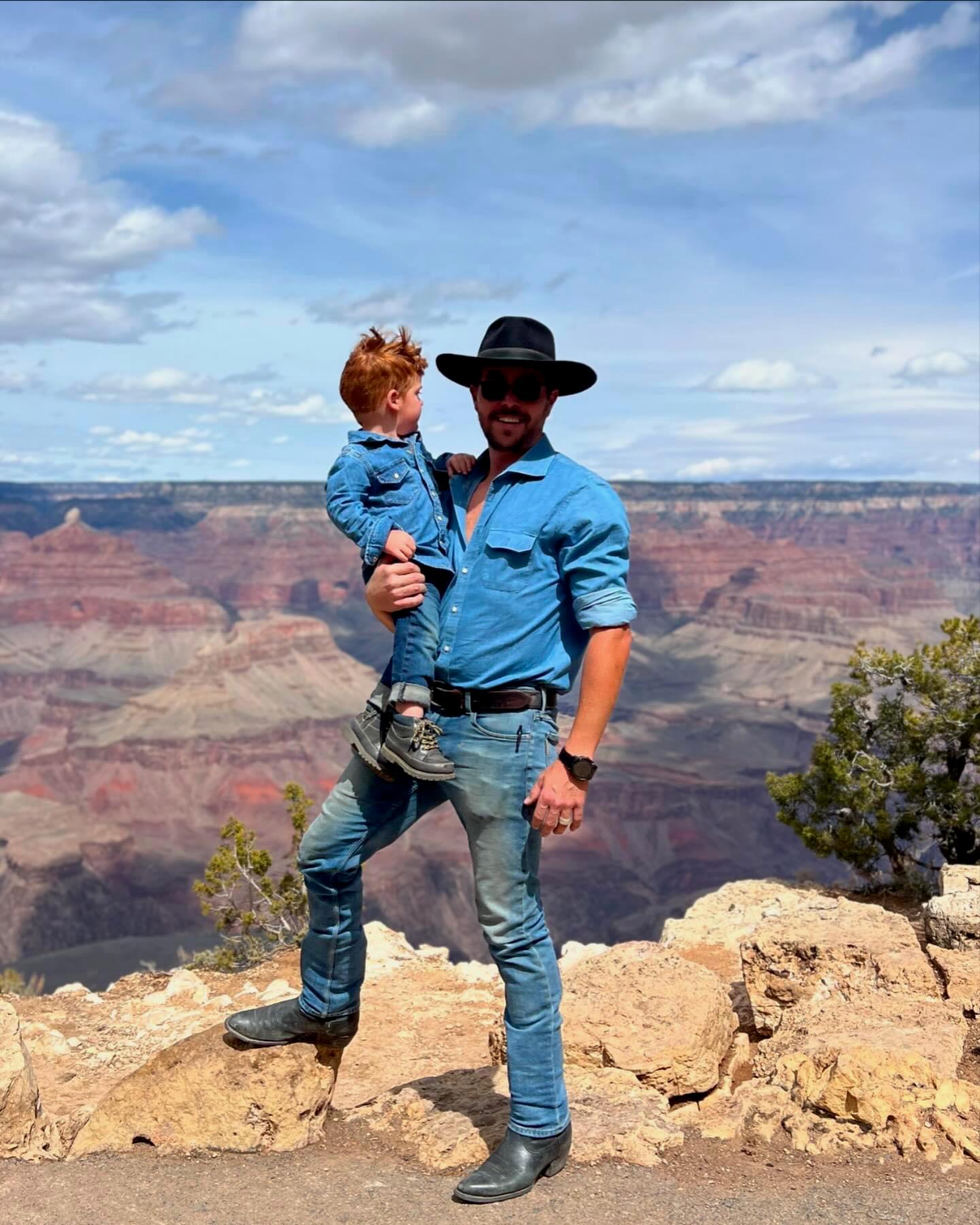 Riley Bowers holding a child during an outdoor trip