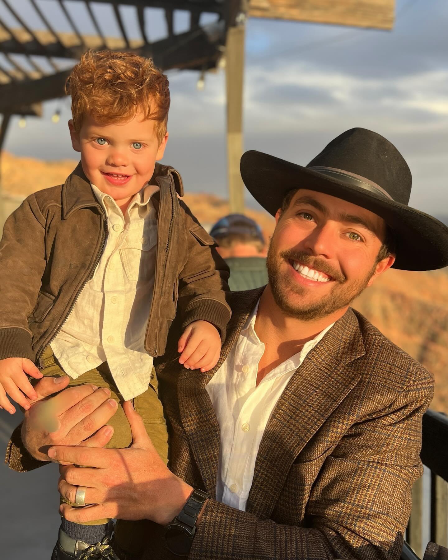 Riley Bowers smiling while holding a child